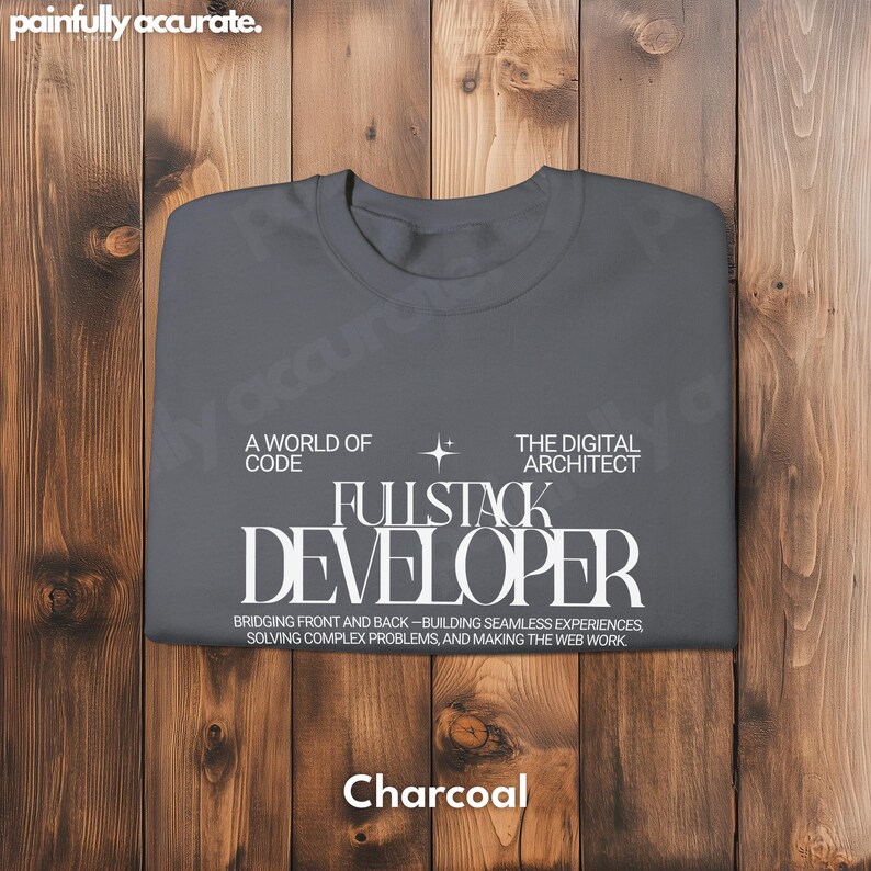 A gray t-shirt with white text and a star graphic, laid out on a wooden surface.