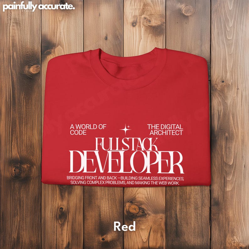 A red t-shirt with white text that says "A WORLD OF CODE FULLSTACK DEVELOPER BRIDGING FRONT AND BACK - BUILDING SEAMLESS EXPERIENCES, SO WINGING COMPLEX PROJECTS AND MAKING THE WEB MORE FUN"