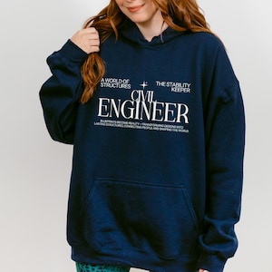 May include: A navy blue hooded sweatshirt featuring white text that reads A WORLD OF STRUCTURES, THE STABILITY KEEPER, CIVIL ENGINEER, and BLUEPRINTS BECOME REALITY—TRANSFORMING DESIGNS INTO LASTING STRUCTURES, CONNECTING PEOPLE AND SHAPING THE WORLD.