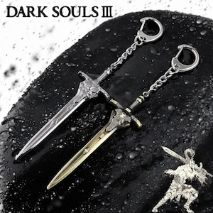 May include: Two silver sword keychains with intricate details. The swords are attached to silver chains with key rings. The swords are on a dark grey background.
