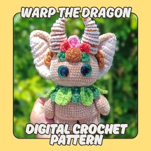 May include: A crocheted dragon doll with large, glittery blue eyes, cream-coloured ears, and decorative horns. The doll has a green leaf-like collar and a floral crown. The text "WARP THE DRAGON" and "DIGITAL CROCHET PATTERN" are displayed.