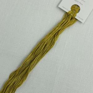 May include: A skein of Split Pea hand-dyed embroidery floss, 7.5m/8.2 yards, in a vibrant yellow-green colour. The floss is bundled and attached to a white product tag with floral illustrations and text.