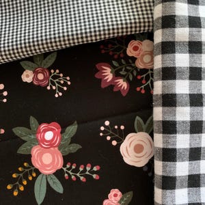 May include: Three fabric swatches, one with a black and white gingham pattern, one with a black and white checkered pattern, and one with a floral pattern on a black background.