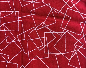 May include: Red fabric with a white geometric pattern of overlapping squares and rectangles.