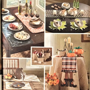 May include: Simplicity pattern 1343 features various home decor projects. The image showcases table settings with plates, glasses, and decorative elements. It includes a chalkboard table runner, pumpkin decorations, and fabric projects.