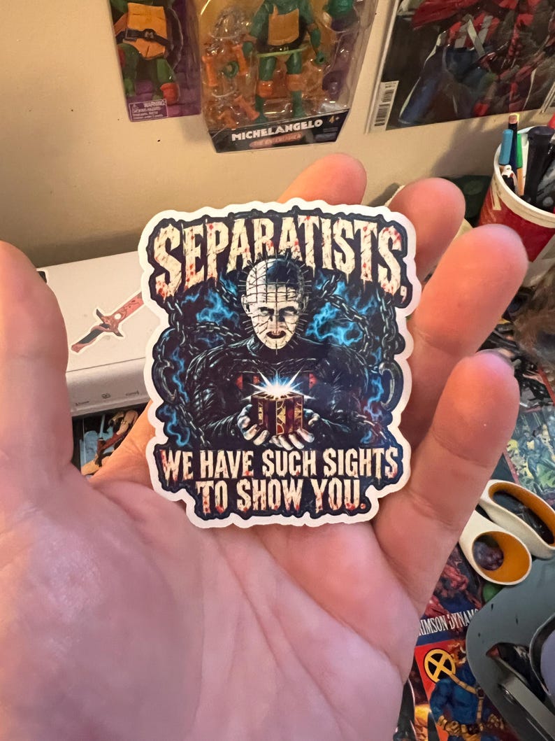 May include: A die-cut vinyl sticker featuring a central illustration of Pinhead from Hellraiser holding a glowing puzzle box, surrounded by blue chains. The text SEPARATISTS appears at the top and WE HAVE SUCH SIGHTS TO SHOW YOU at the bottom.