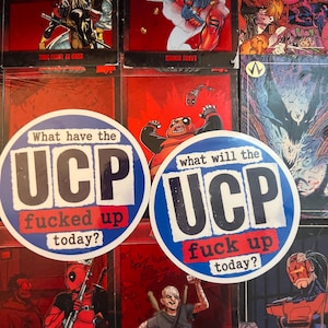 May include: Two circular stickers featuring a blue border and white background with the bold black text UCP. The left sticker reads What have the UCP fucked up today? and the right sticker reads what will the UCP fuck up today? in red and black.