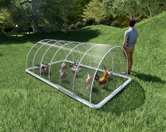 May include: A white, rectangular, wire-mesh chicken coop with a clear plastic cover. The coop is on a grassy lawn and there are several chickens inside.