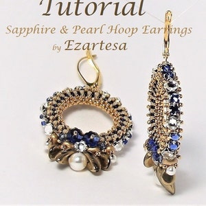 May include: A pair of gold hoop earrings with blue and white beads, a pearl, and a gold hook closure. The earrings are called "Sapphire & Pearl Hoop Earrings by Ezartesa".