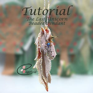 May include: A beaded unicorn pendant with a gold horn, blue eye, and cream, red, and gold accents. The pendant is suspended from a delicate beaded chain. Text on the image reads "Tutorial The Last Unicorn Beaded Pendant" and the logo "Zartesa".