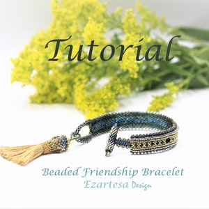 May include: Beaded friendship bracelet tutorial featuring a blue, green and gold colour scheme. The bracelet has a tassel and a toggle clasp. The text "Tutorial" is written in a decorative font above the bracelet. The text "Beaded Friendship Bracelet" and "Ezartesa Design" are written below the bracelet.