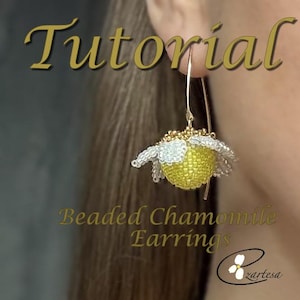 May include: A close-up of a beaded chamomile earring. The earring is yellow, white, and gold, with a daisy-like design. The image includes the text "Tutorial" and "Beaded Chamomile Earrings". The earring is suspended from a gold hook.
