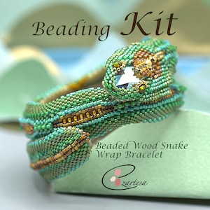 May include: Beaded Wood Snake Wrap Bracelet kit. The bracelet is green and gold with a crystal bead in the snake's head. The kit includes all the beads and instructions needed to make the bracelet.