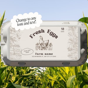 May include: A gray egg carton with a label that reads "Fresh Eggs" and features a hen illustration. The label also includes the text "Farm name" and "10 Eggs". The background shows corn stalks and a blue sky.