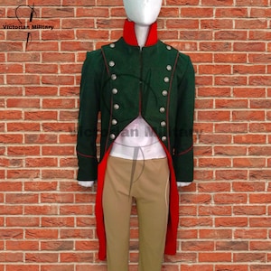 Puede incluir: Una chaqueta militar verde con ribetes rojos y botones plateados se exhibe en un maniquí. La chaqueta tiene cuello alto y colas largas. El texto "Victorian Military" es visible en la esquina superior izquierda.