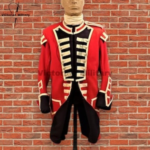 May include: A red military jacket with black and white accents, displayed on a mannequin. The jacket features a high collar, silver buttons, and decorative trim. The text "Victorian Military" is visible in the upper left corner.