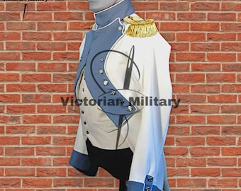 May include: A white military jacket with blue accents, gold epaulettes, and decorative buttons. The jacket is displayed on a mannequin against a brick wall. The text "Victorian Military" is visible.