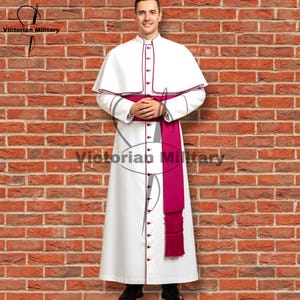 May include: A white clerical robe with a matching cape, trimmed in burgundy. A magenta sash is worn around the waist. The robe has a button-down front. The text "Victorian Military" is visible in the image.