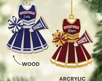 May include: Two cheerleader-themed ornaments. One is navy blue with white and silver accents, the other is maroon with gold and white accents. Each has a megaphone with "2025" and a pom-pom. The text "SPIRIT STAR" and a name are on the top.