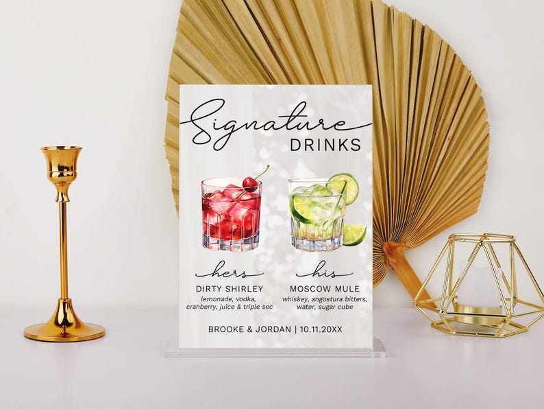 May include: A white sign with the text "Signature Drinks" and two cocktails, one red and one green, with the names "Dirty Shirley" and "Moscow Mule" and their ingredients listed below. The sign also includes the names "Brooke & Jordan" and the date "10.11.20XX".