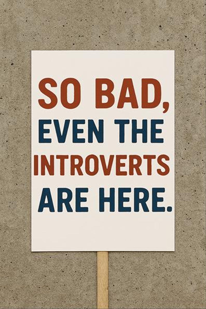 a white sign with red and blue text that reads “so bad, even the introverts are here.”