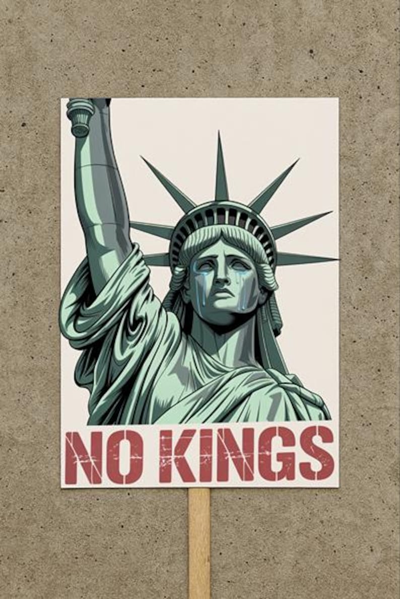 a sign with an image of the Statue of Liberty above bold red text that reads “no kings”