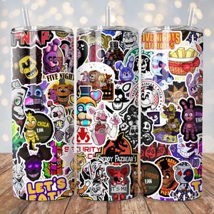 May include: Three stainless steel tumblers featuring colourful graphics of characters from the video game Five Nights at Freddy's. The tumblers feature a variety of characters, including Freddy Fazbear, Chica, Bonnie, and Foxy. The tumblers are all decorated with a variety of colourful stickers and graphics.