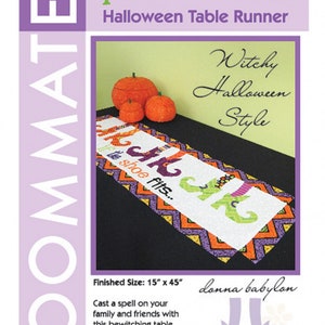 May include: Halloween table runner with the text "If the shoe fits..." and witchy feet. The runner is white with orange, purple, and green accents. Finished size is 15" x 45".