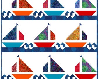 May include: A quilt pattern titled Regatta by Pink Parakeet Designs featuring rows of colourful sailboats on a dark blue background. The sailboats have patterned sails in shades of red, orange, green, and blue. The text reads Fat Quarter Friendly.