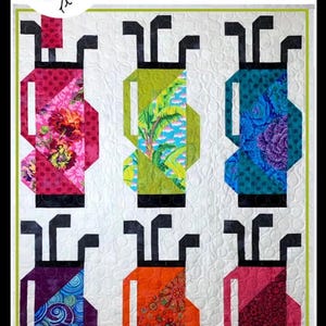 May include: A colorful quilt featuring six golf bag designs. Each bag is a different color and pattern, including floral and geometric prints. The word "FORE!" is at the top, and the words "Fat Quarter Friendly" are at the bottom.