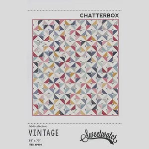 May include: A quilt pattern titled "Chatterbox" from the "Vintage" fabric collection. The quilt features a geometric design with triangles in various colors, including pink, blue, yellow, and gray. The quilt measures 65" x 73".
