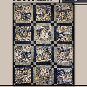 May include: Klondike quilt featuring a repeating pattern of wolves in a forest setting. The quilt has a dark blue border and the text "Klondike" is at the top. The words "Villa Rosa Designs" are at the bottom. A white rose is in the upper right corner.