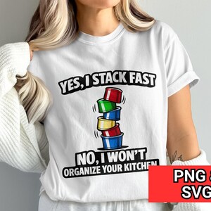 May include: White t-shirt with the text "YES, I STACK FAST, NO, I WON'T ORGANIZE YOUR KITCHEN" in black. The shirt features a graphic of stacked colorful containers. The image also includes the text "PNG & SVG" in a red box.