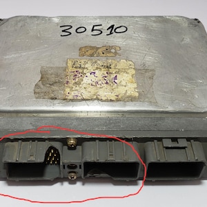 May include: A silver-colored electronic component with the number 30510 printed on the top. The component has two black connectors on the bottom.