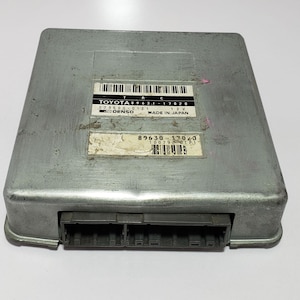 May include: A silver automotive control unit with the text "TOYOTA 89631-12020 029500-0121 MADE IN JAPAN DENSO 89630 12043 100792 0161" printed on it.