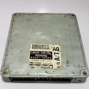 May include: A gray Toyota engine control unit with the part numbers 89661-30890 and 175800-1581. The unit is labeled "21-TE A/T" and "AQ".