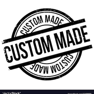 May include: A black and white circular stamp with the words "CUSTOM MADE" in a bold, sans-serif font. The words are arranged in a circular pattern and also across the center of the stamp. The stamp has a distressed, vintage look.