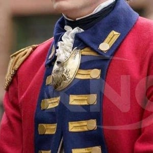 May include: A red military jacket with gold epaulets and gold buttons. The jacket has a navy blue collar and lapels with gold trim. A gold decorative piece is attached to the jacket.