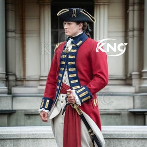 May include: A red military-style coat with blue and gold trim, a black hat, and a sword. The coat features gold epaulets and a high collar. The outfit is completed with a white vest and breeches, and a red sash.