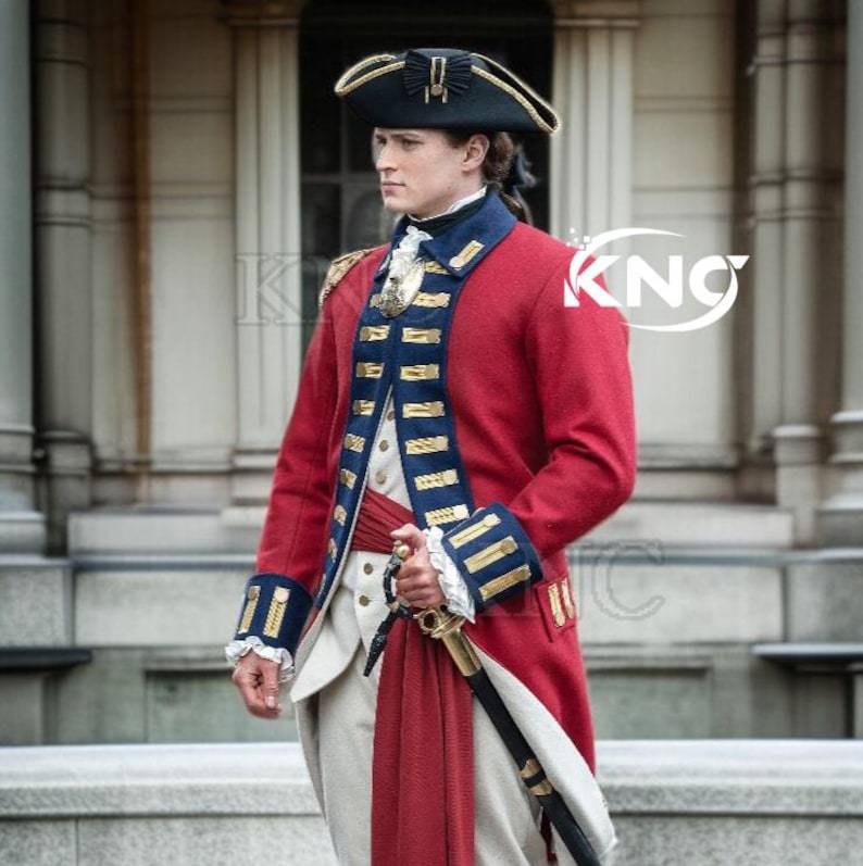 May include: A red military-style coat with blue and gold trim, a black hat, and a sword. The coat features gold epaulets and a high collar. The outfit is completed with a white vest and breeches, and a red sash.