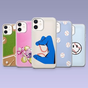 May include: A collection of five phone cases with various designs. One case features a baseball field, another a pink background with softballs and a bow, and a third showcases a blue hand holding a baseball. The remaining cases display baseballs and a smiley face.