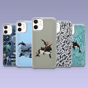 May include: Five different phone cases with various designs featuring orcas. The cases are all clear and show the phone's camera lens. One case has a collage of orcas in different poses, another has a single orca swimming, another has two orcas swimming together, another has a pattern of orcas, and another has a pattern of orcas and coral.