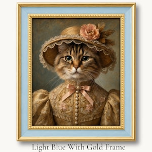 Tabby cat in a flowered straw bonnet and cream Victorian dress in a light blue with gold picture frame.
