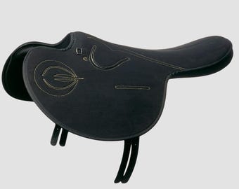 May include: A black English saddle with gold stitching. The saddle features a padded seat, a raised cantle, and stirrup leathers. The saddle is designed for equestrian activities and is made of a durable material.