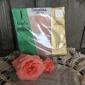 May include: A package of seamless stretch nylon hosiery. The package is green and gold with the words "Lovely Hosiery" and "Seamless Stretch" printed on it. The package also includes a size chart and the text "First Quality 100% Nylon".