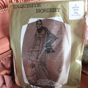 May include: A package of Exquisite Hosiery in a brown color with a woman in a coat and a dog on the front. The package has a price tag that says 9 Coffee $2.50 79¢ RN #14595.