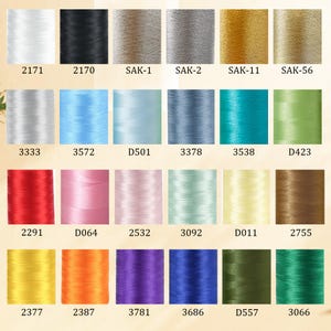 May include: A collection of colorful spools of thread, each labeled with a unique number. The threads vary in color, including white, black, gold, blue, green, red, pink, and yellow. The image is well-lit, showcasing the vibrant hues of the threads.