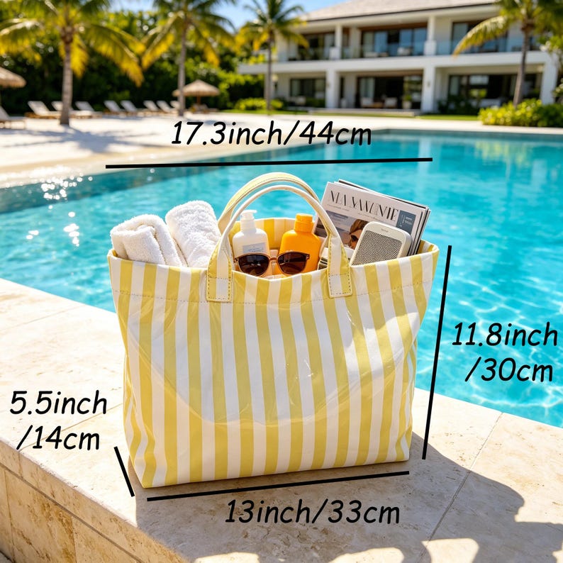 May include: Yellow and white striped tote bag, 17.3 inches (44 cm) wide, 11.8 inches (30 cm) tall, and 5.5 inches (14 cm) deep. The bag contains white towels, sunglasses, sunscreen, and a magazine. The bag is sitting by a pool.