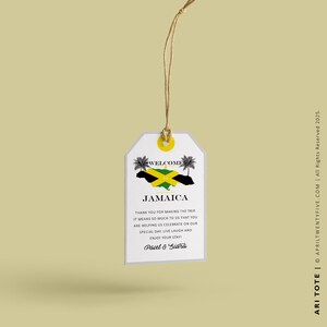 May include: A white welcome tag with a string attached. The tag features a Jamaican flag and the text "Welcome Jamaica". The text below the flag reads "Thank you for making the trip. It means so much to us that you are helping us celebrate on our special day. Live, laugh and enjoy your stay! Paul & Sidra"