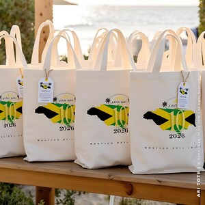 May include: White canvas tote bags with black handles. Each bag features a green, yellow, and black Jamaican flag design with the text "Jamaica 10 2026" printed on the front.